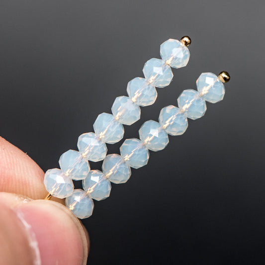 May include: Two gold hair clips with white opal beads. Each clip has 10 beads.