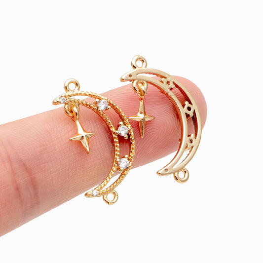 May include: Two gold-colored crescent moon charms with star pendants. One moon has a beaded edge with clear crystal accents. The other moon has a decorative openwork design. Both charms have small loops for attaching to jewelry.