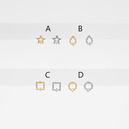 May include: Six small gold and silver jewelry pieces with a single diamond in the center of each piece. The pieces are shaped like a star, a teardrop, a square, and a circle. The pieces are labeled with the letters A, B, C, and D.