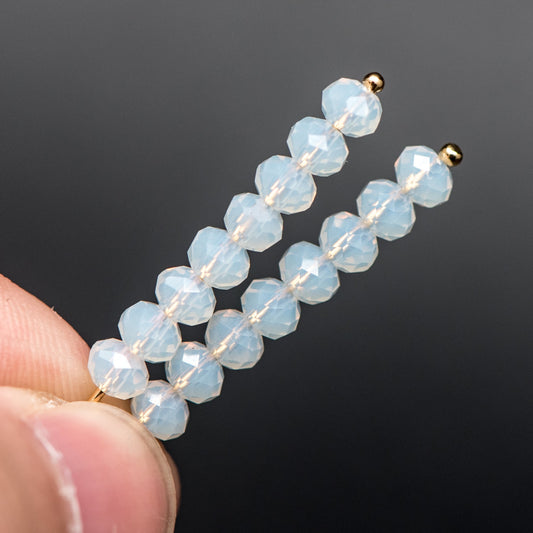 May include: Two gold hair clips with white opal beads. Each clip has 10 beads.