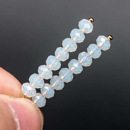 May include: Two gold hair clips with white opal beads. Each clip has 10 beads.